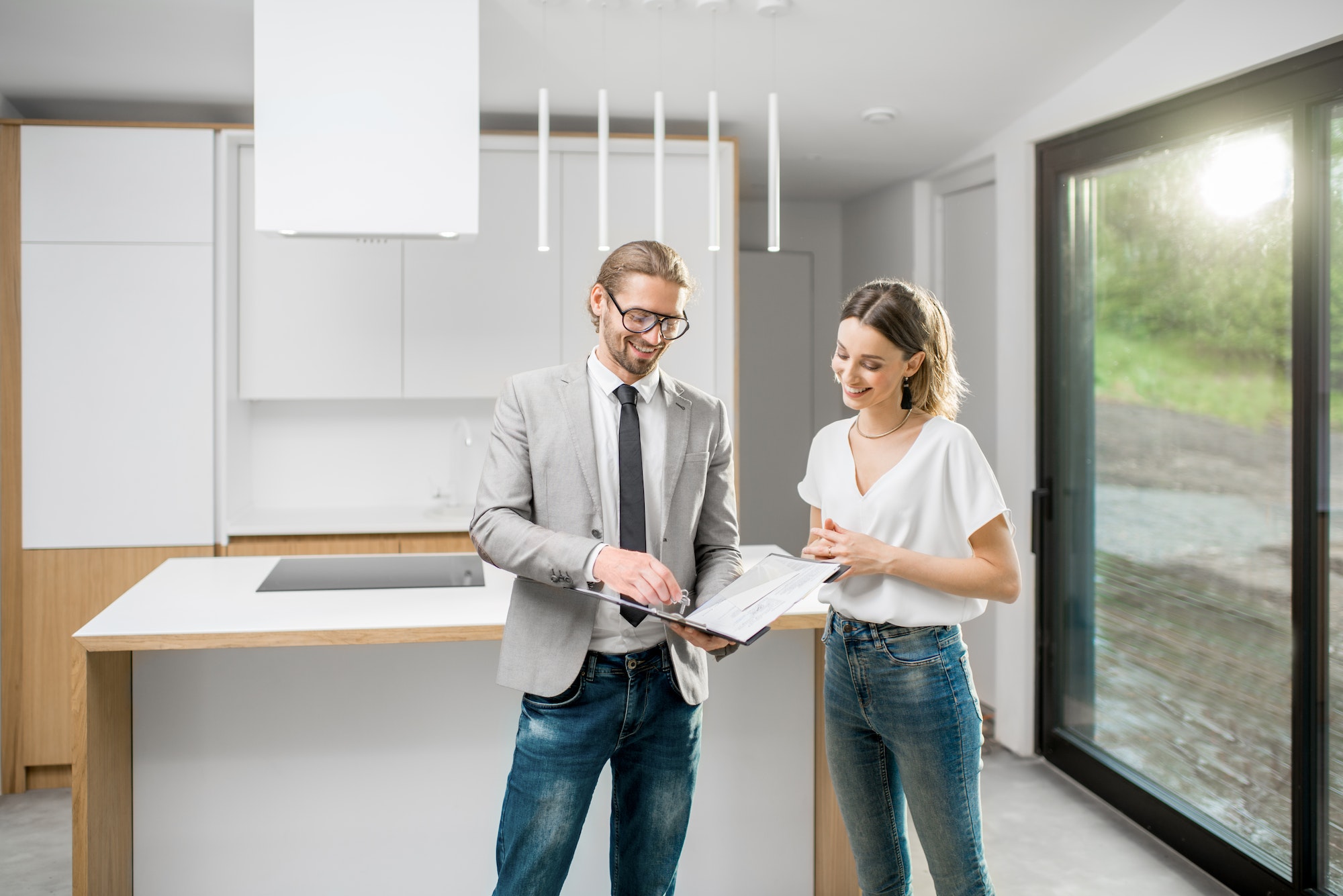 Woman with realtor in the modern apartment